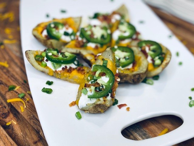 s 8 easy potato thanksgiving side dish recipes, Cheesy Baked Potato Skins With Jalapenos