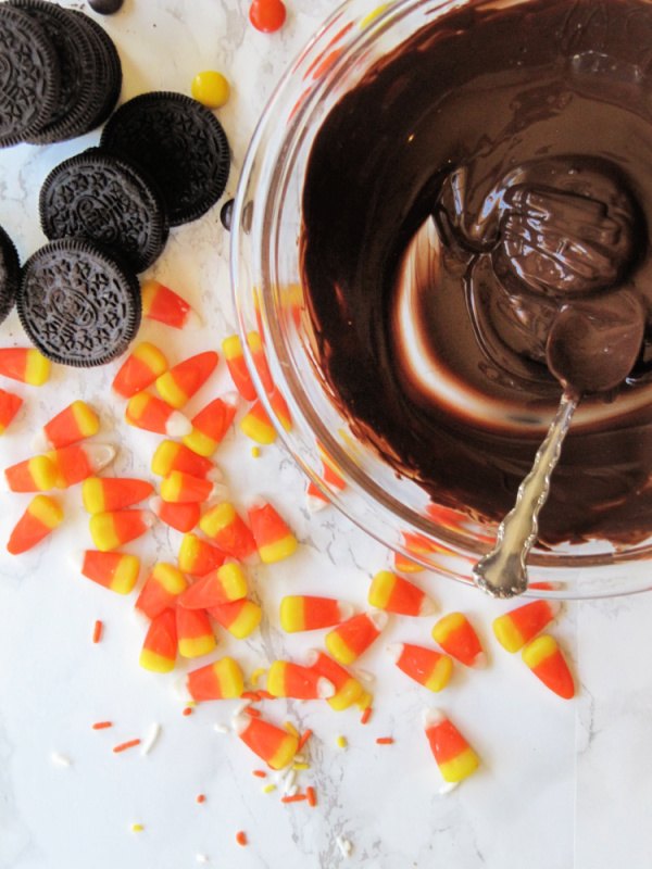halloween chocolate covered oreos, Melted Chocolate Candy Corns and Oreo Cookie