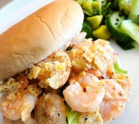shrimps on a bun with a citrusy side salad