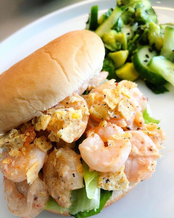 shrimps on a bun with a citrusy side salad