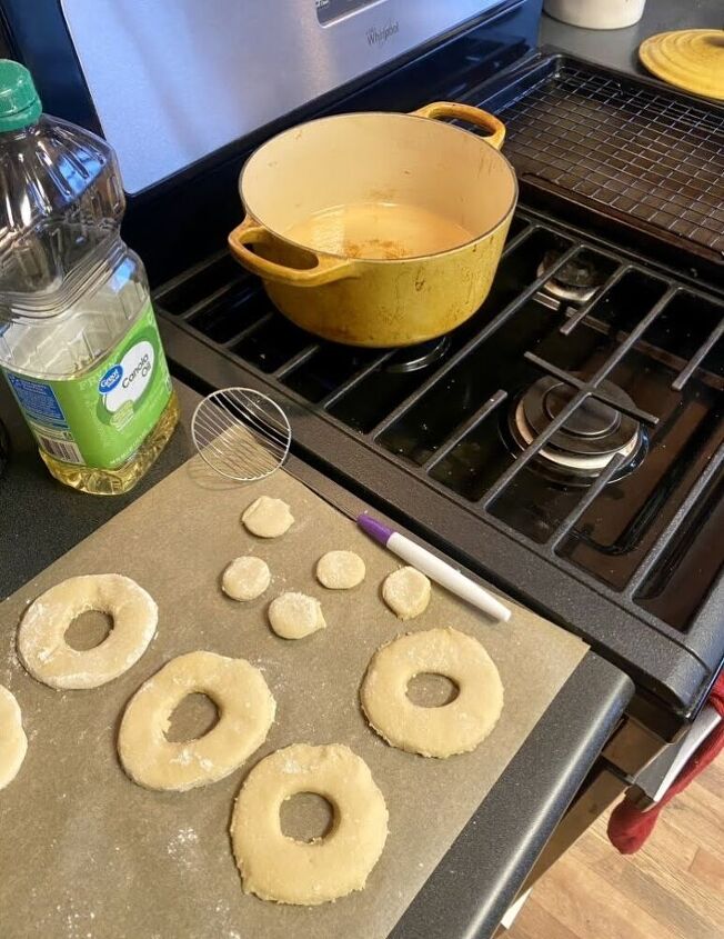 This is what my set up looks like for frying my donuts! I have parchment paper out to place the dough, then I use a candy dipper (linked above) to flip the donuts in the oil (a spoon or fork works as well). Then I have a cookie sheet with a drying rack over it ready for the cooked donuts to dry/cool.