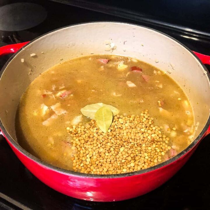 sausage lentil soup, Pour in the broth and add the lentils and bay leaves