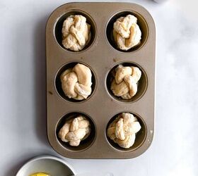 everything bagel braided brioche knots, Wrap the knot and place in a greased muffin pan