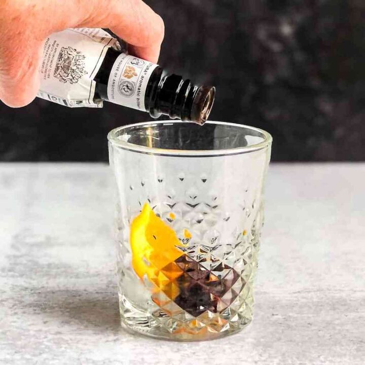 maple syrup old fashioned, Add orange slice cherries and bitters to a rocks glass