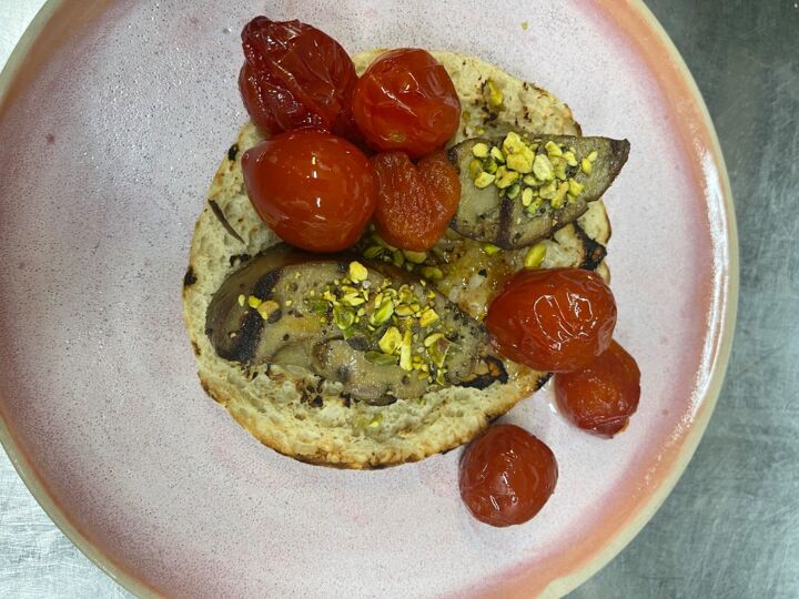grilled goose liver on pita with tomato jam and pistachios