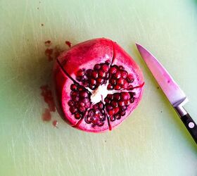 , Cut the top off the pomegranate then slice along the segments