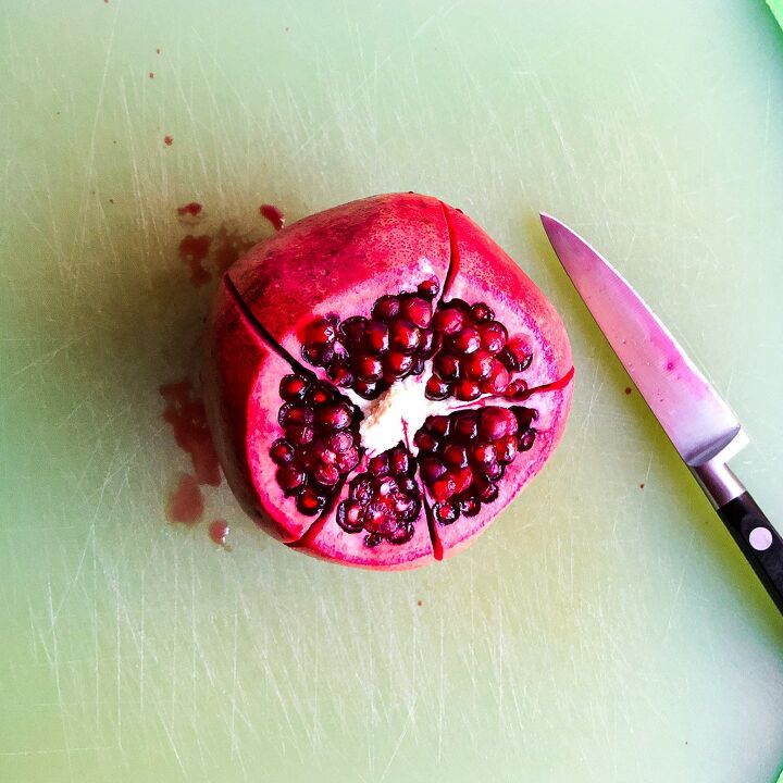 , Cut the top off the pomegranate then slice along the segments