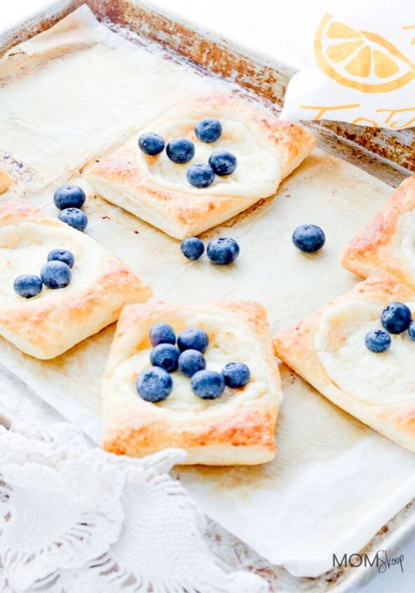 easy puff pastry cheese danish, Classic Cheese Danish on a piece of parchment paper