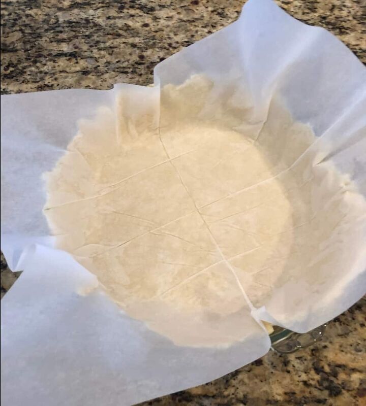 , Roll out pie dough between 2 pieces of parchment paper Remove one and place into pie plate Once positioned remove top piece