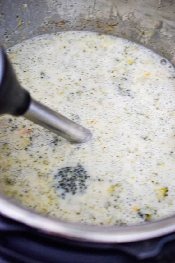 instant pot broccoli cheddar soup, An immersion blender is blending the soup