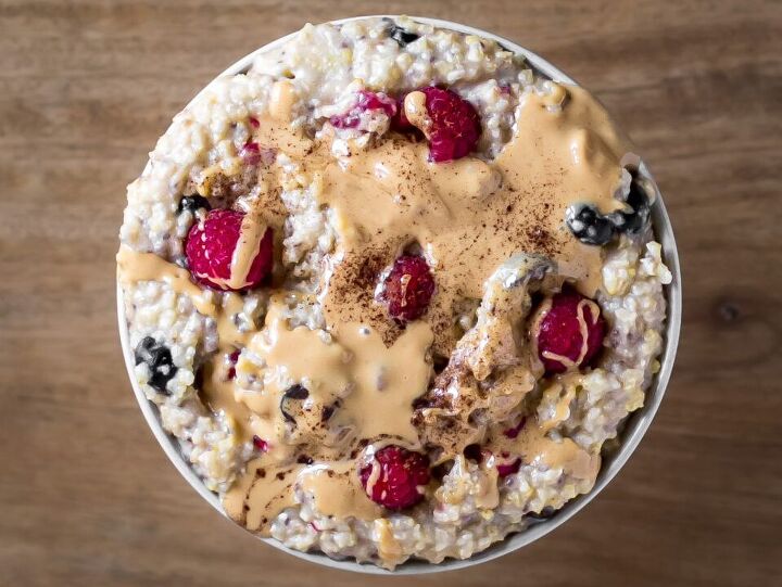 millet porridge, Millet Porridge with fresh raspberries and blueberries topped with almond butter