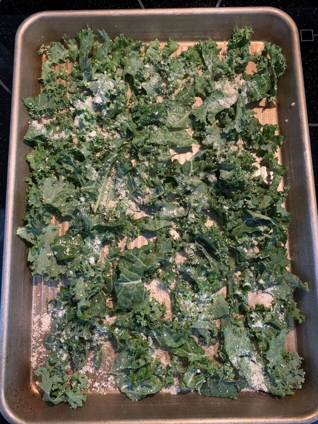 crunchy parmesan kale chips, Kale with olive oil and cheese ready to be baked