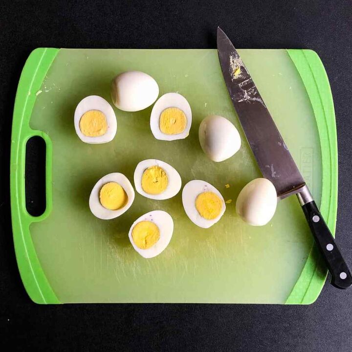 avocado deviled eggs with bacon, Cut boiled eggs in half