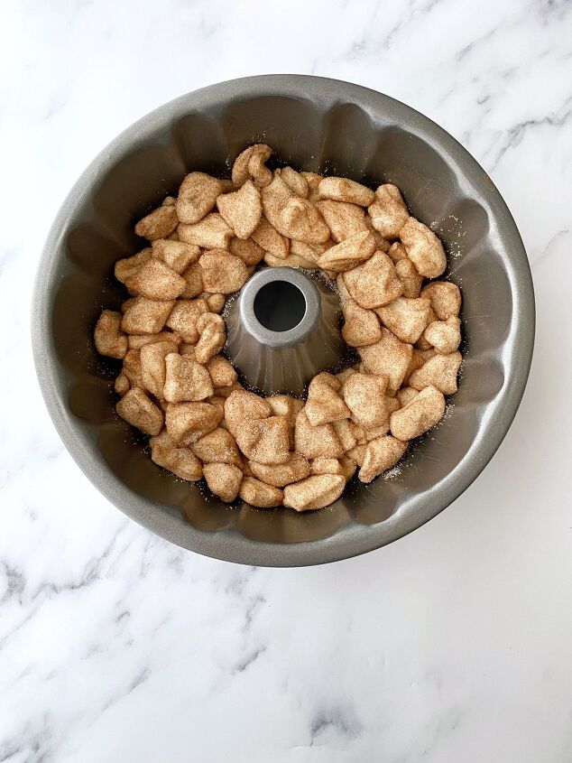 easy cinnamon sugar monkey bread, Layering the biscuits in the bundt pan Besides eating the monkey bread this step is my girls favorite part of the process