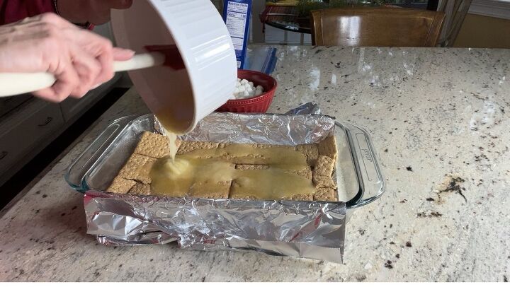 delicious s mores bars for your end of summer bash, Here I am spreading the sugar butter mixture over the graham crackers using a rubber spatula