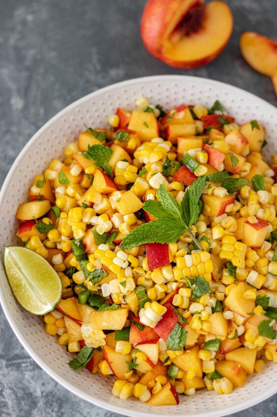 fresh nectarine corn salsa, Ingredients like fresh diced nectarines sweet corn diced jalapeno peppers fresh mint and a lime wedge in a large serving bowl
