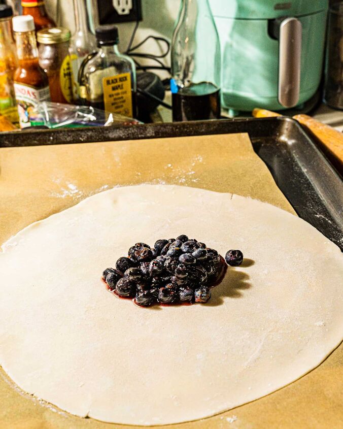 easy blueberry galette, berry filling in center of galette dough