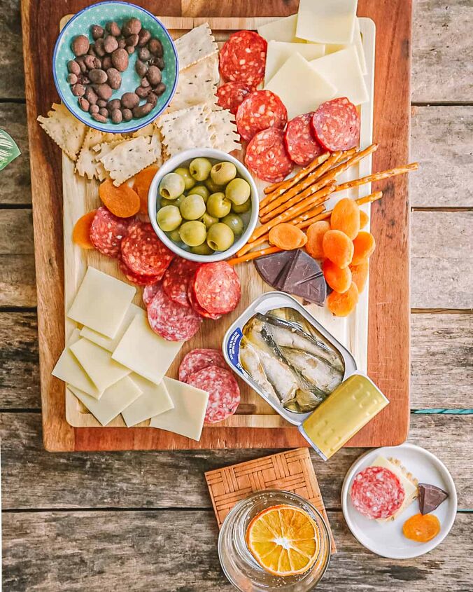 easy small charcuterie board for two, Wide op down shot of small charcuterie board with pepperoni cheese olives and other snacks