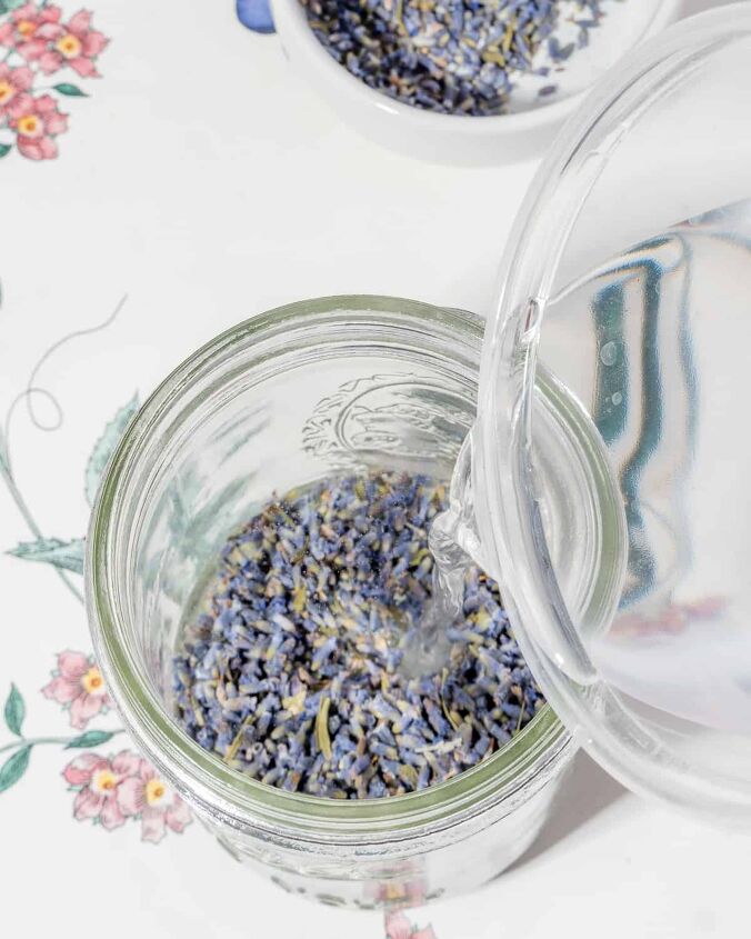 honey lavender lemonade, person adding water to dried lavender buds in a mason jar