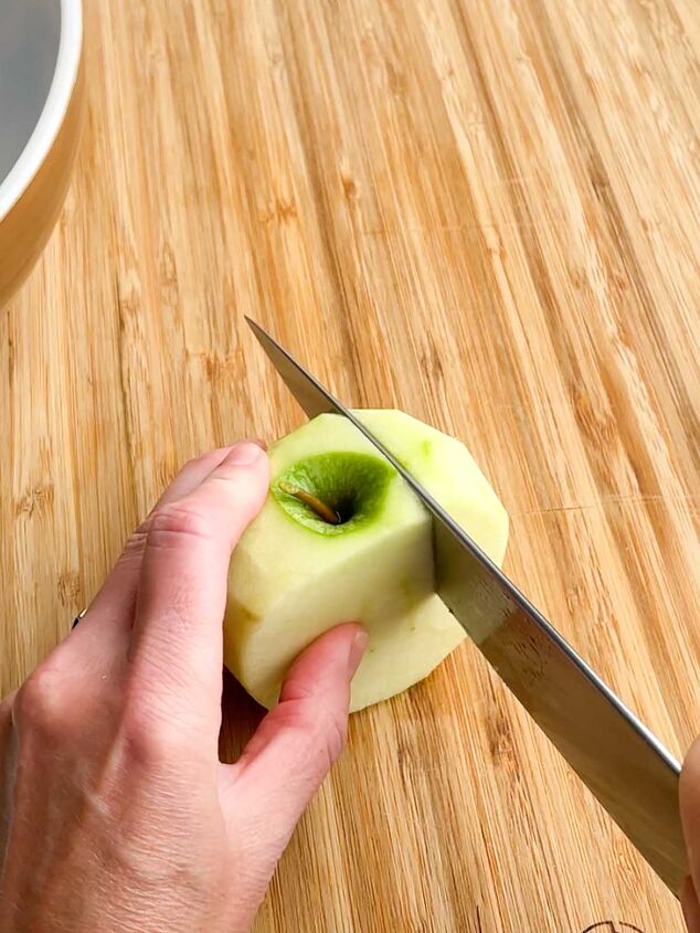 apple crisp without oatmeal, knife making a vertical cut through an apple