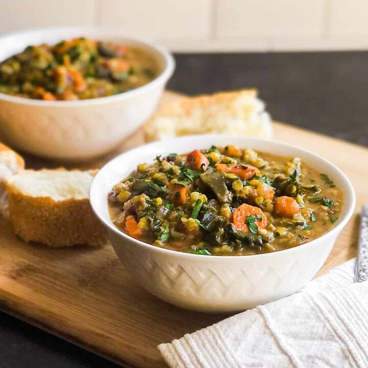 vegetarian lentil farro stew, Vegetable stew in a white bowl with second bowl blurred in background