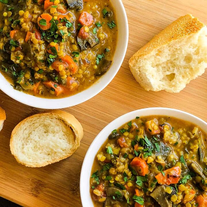 vegetarian lentil farro stew, Two bowls of stew on a wood cutting board