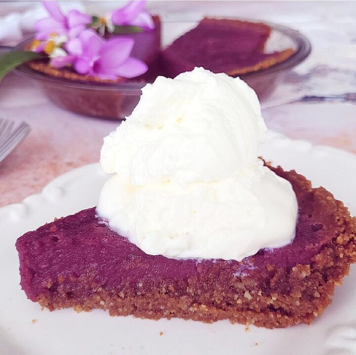 purple sweet potato pie, functional image purple sweet potato pie side view to see gingersnap crust filling and whipped cream topping up close pie dish in background