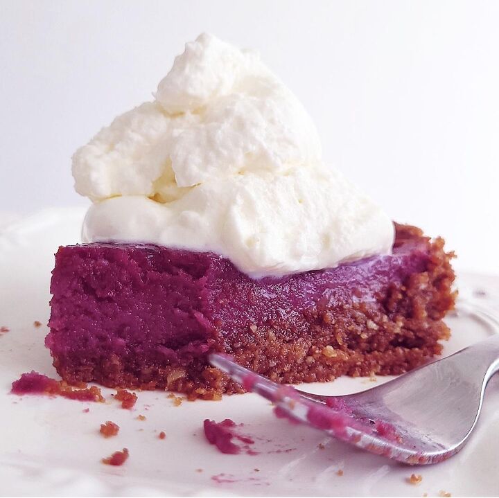 purple sweet potato pie, functional image purple sweet potato slice of pie on a white place with whipped cream on top and a fork with purple filling on it from the first bite