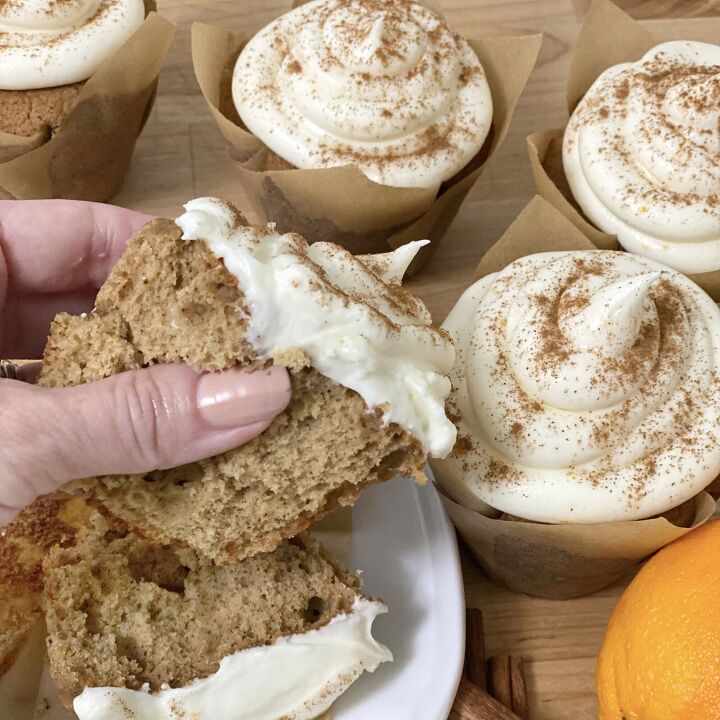 orange spice cupcakes, A hand holding a piece of cupcake to show the cakey inside
