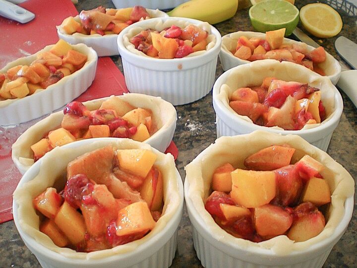 how to make mini peach raspberry pies in ramekins, ramekins filled with pie dough and peaches