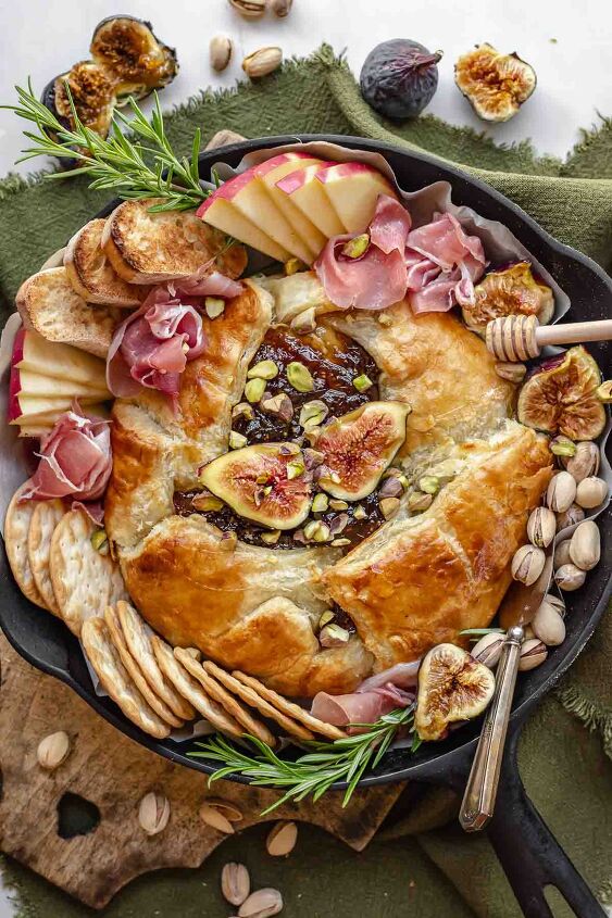 baked brie with fig jam, Finished baked brie in a cast iron skillet with dippers scattered around