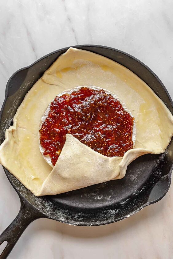 baked brie with fig jam, A corner of puff pastry folds up onto the brie and fig jam