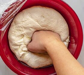 homemade pepperoni bread, A hand punches down risen dough in a bowl