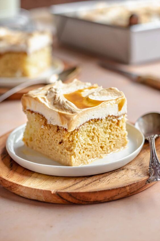 caramel tres leches cake, A piece of cake on a plate with a spoon next to it