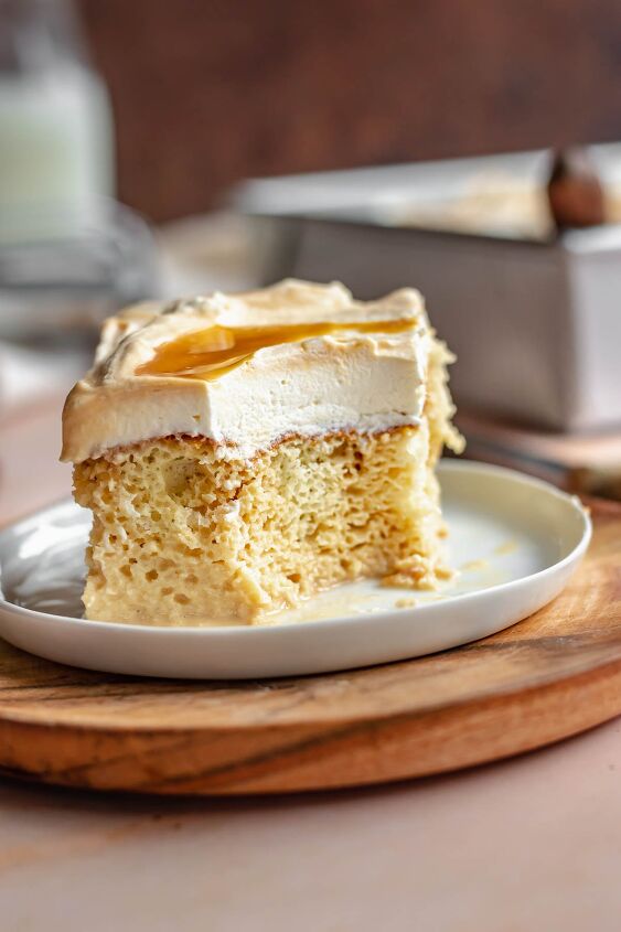 caramel tres leches cake, A piece of tres leches cake on a plate with a bite removed