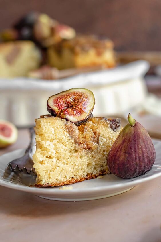 upside down almond fig cake, Fig cake on a plate with a fig on top and fork next to it