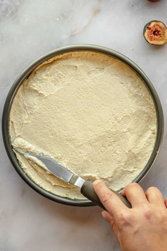 upside down almond fig cake, An offset spatula spreading cake batter evenly in a pan
