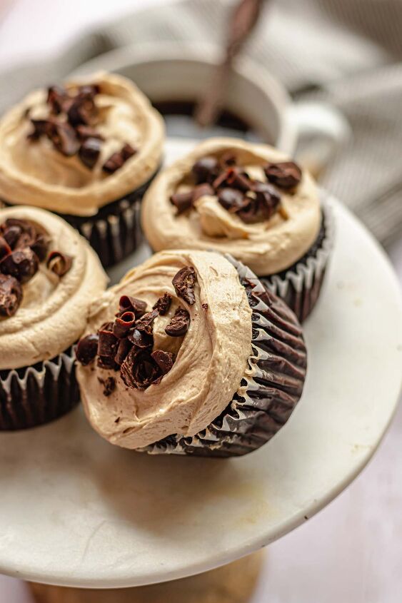 chocolate mocha cupcakes with espresso frosting, Four mocha cupcakes on a stand one leans over resting on the others