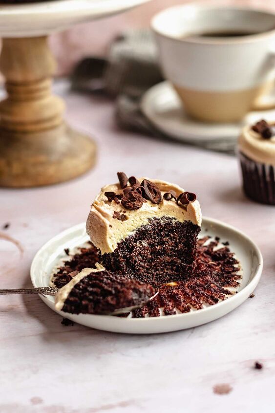 chocolate mocha cupcakes with espresso frosting, Mocha cupcake on a plate with a bite removed sitting on a spoon