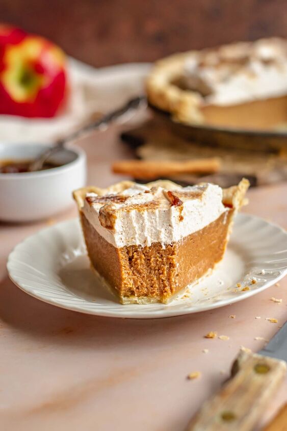 apple butter pie with cinnamon whipped cream, A slice of apple butter pie on a plate with a bite removed