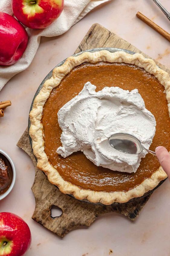 apple butter pie with cinnamon whipped cream, A spoon swooping cinnamon whipped cream on apple butter pie