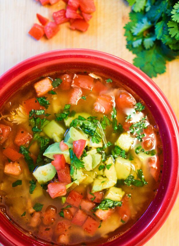 healthy chicken lime avocado soup, Red bowl filled with healthy lime chicken avocado soup