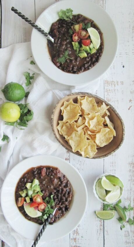 easy slow cooker black bean soup, easy black bean soup 2 white bowls wood bowl of scoops chips and limes 2