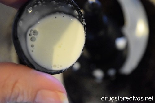 Heavy cream being poured into a food processor