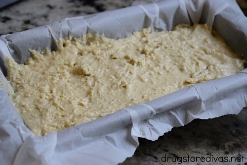 Bread batter in a parchment paper lined loaf pan
