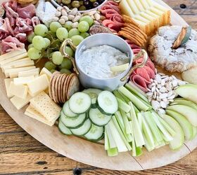what we put on a fall charcuterie board, wooden board filled with cheese deli meats crackers and more for a fall charcuterie board