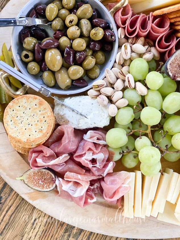what we put on a fall charcuterie board, overview of a board with meats cheese olives and grapes