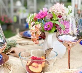 what we put on a fall charcuterie board, outdoor tablescape with bowl of fruit fresh flowers and rose gold table settings