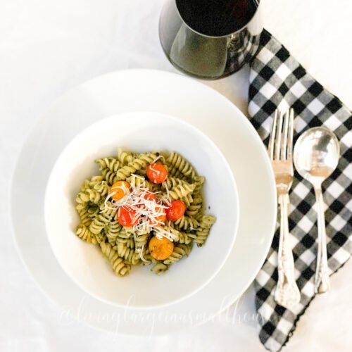 easy homemade alfredo sauce only better, table set with bowl of roasted cherry tomato pesto pasta