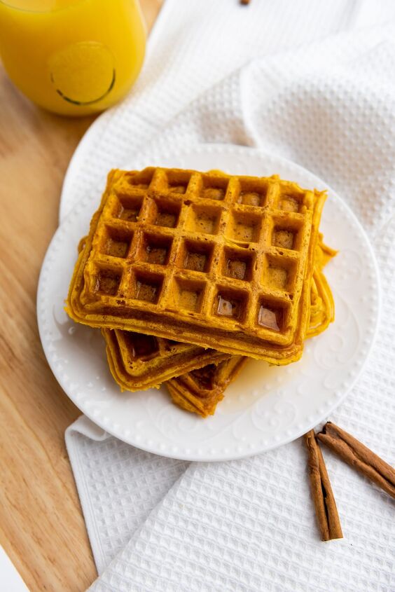 best ever pumpkin spice waffle recipe, pumpkin waffles on a white plate
